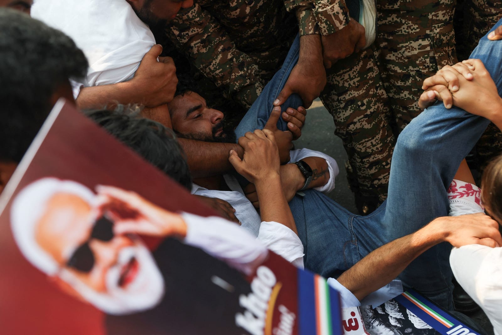 A protester reacts as he is detained by security personnel during a protest seeking the resignation of India's Chief Election Commissioner, Gyanesh Kumar, in New Delhi, India, October 13, 2026. REUTERS/Priyanshu Singh