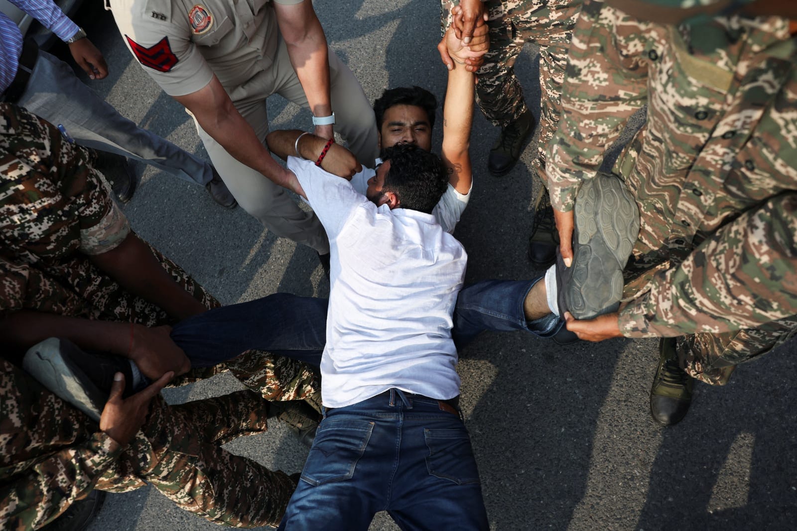 Protesters react as they are detained by security personnel during a protest seeking the resignation of India's Chief Election Commissioner, Gyanesh Kumar, in New Delhi, India, October 13, 2026. REUTERS/Priyanshu Singh