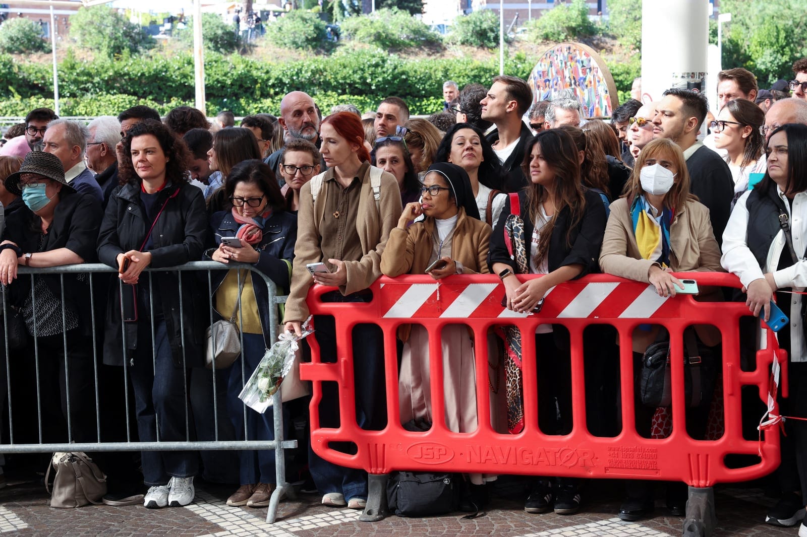 People wait for the Pope Leo's arrival at Gemelli Hospital, where he is expected to be hospitalised to undergo surgery to remove a small growth on his lung, in Rome, Italy, October 13, 2026. REUTERS/Ciro de Luca