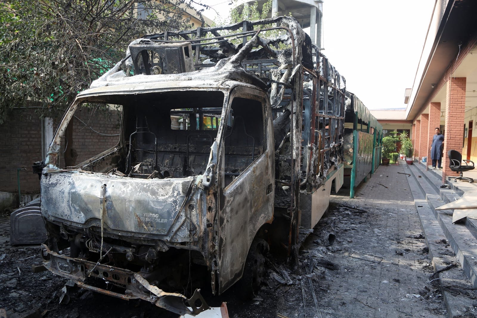 A damaged vehicle stands in the premises of a government office after it was vandalised by protesters, following Pakistan's imposition of a state of emergency in Khyber Pakhtunkhwa province and the suspension of the provincial government led by jaile