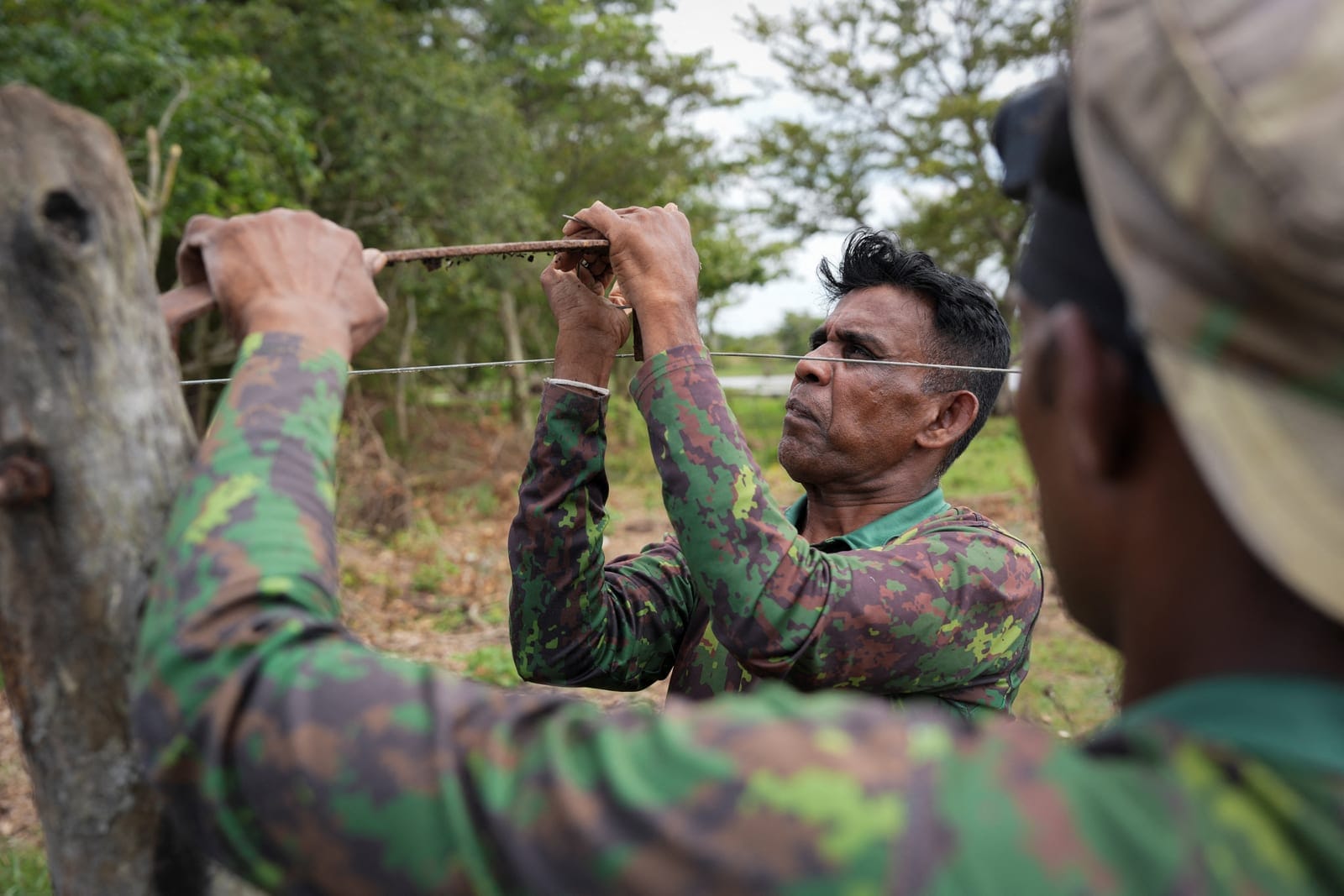 Wildlife officer Dewagiri Mudiyanselage Thilakaratne Bandara, 48, repairs a broken electric fence in Siyambalangamuwa, Sri Lanka, September 16, 2026. An average of 138 people have been killed in encounters with the animals each year in Sri Lanka sinc
