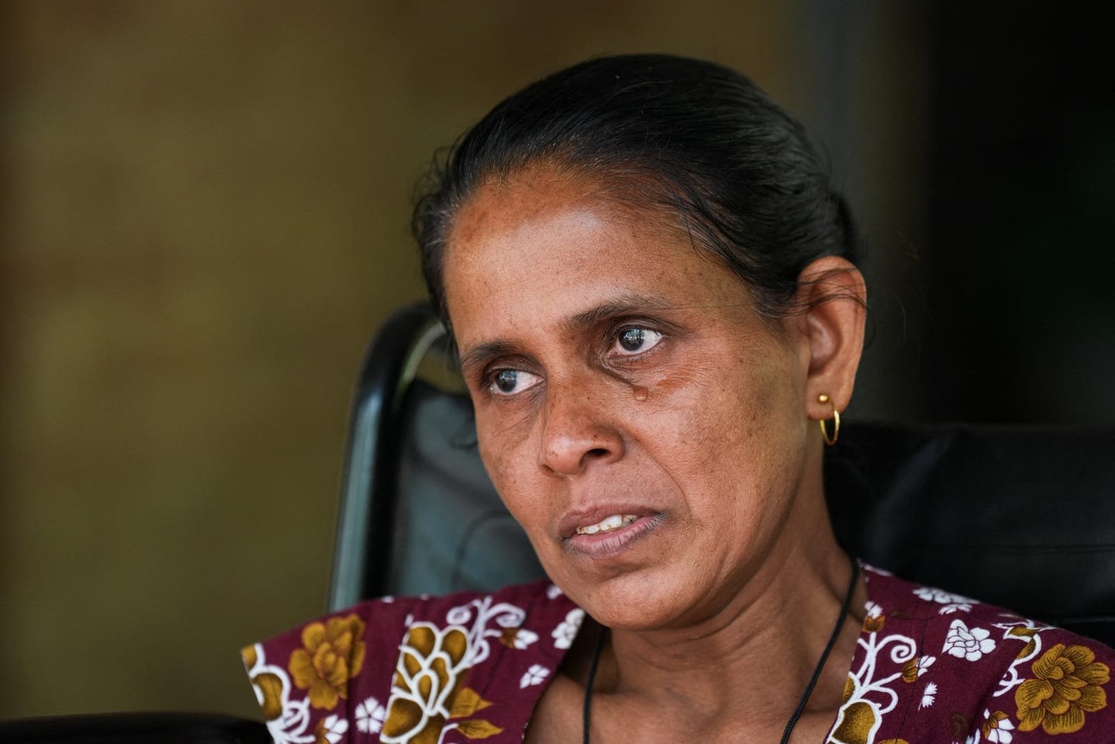 Rathnayake Mudiyanselage Shirani Ratnayake, 48, cries as she remembers the elephant attack in Siyambalangamuwa, Sri Lanka, September 17, 2026. Last December, an elephant wandered into her home's backyard to snack on mangoes, it attacked her husband,