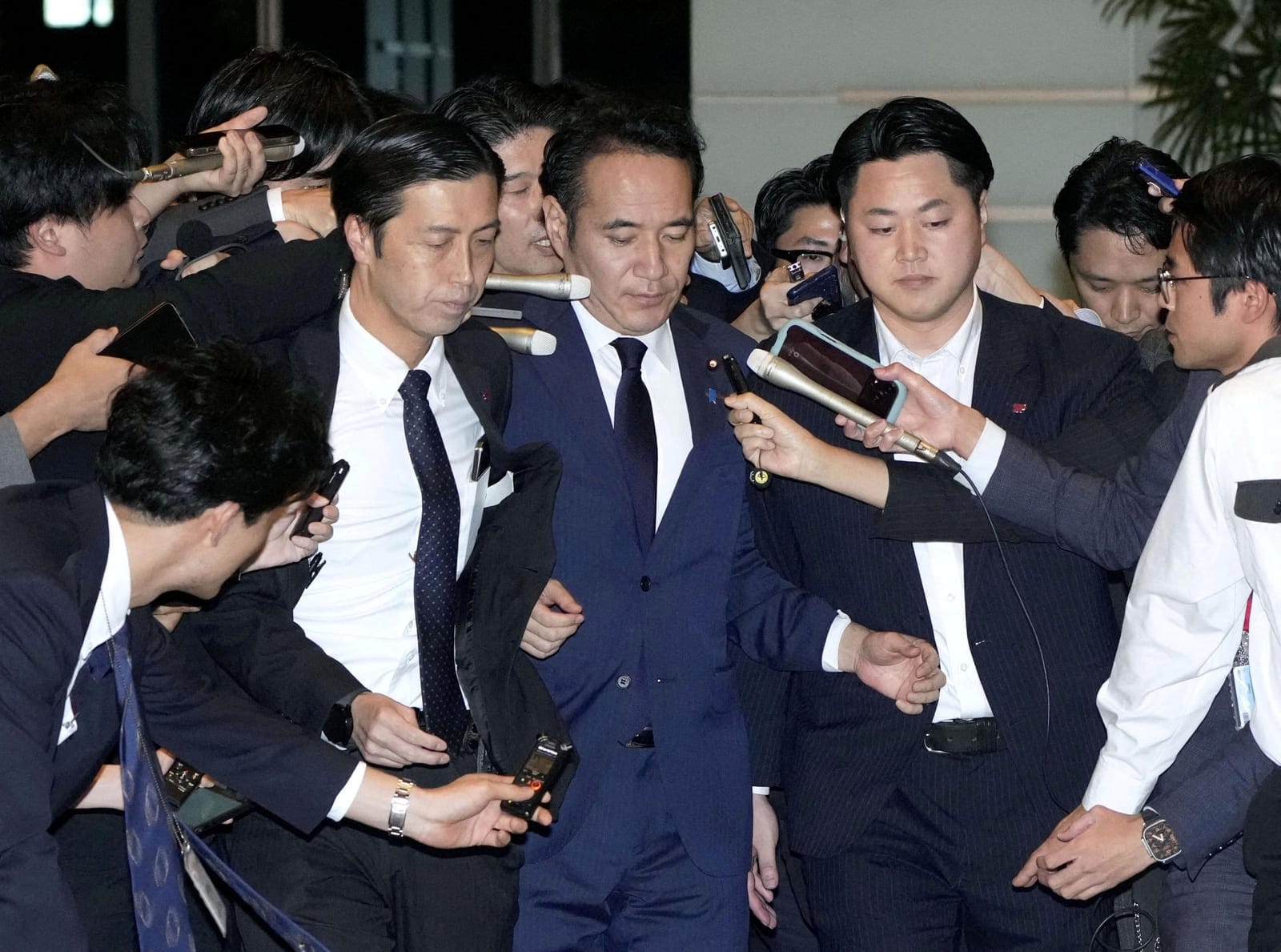 Japan's Minister for Agriculture, Forestry and Fisheries Kazuo Yana is surrounded by reporters as he arrives at Prime Minister Sanae Takaichi's official residence to convey his intention to resign to Takaichi, in Tokyo, Japan October 14, 2026, in thi