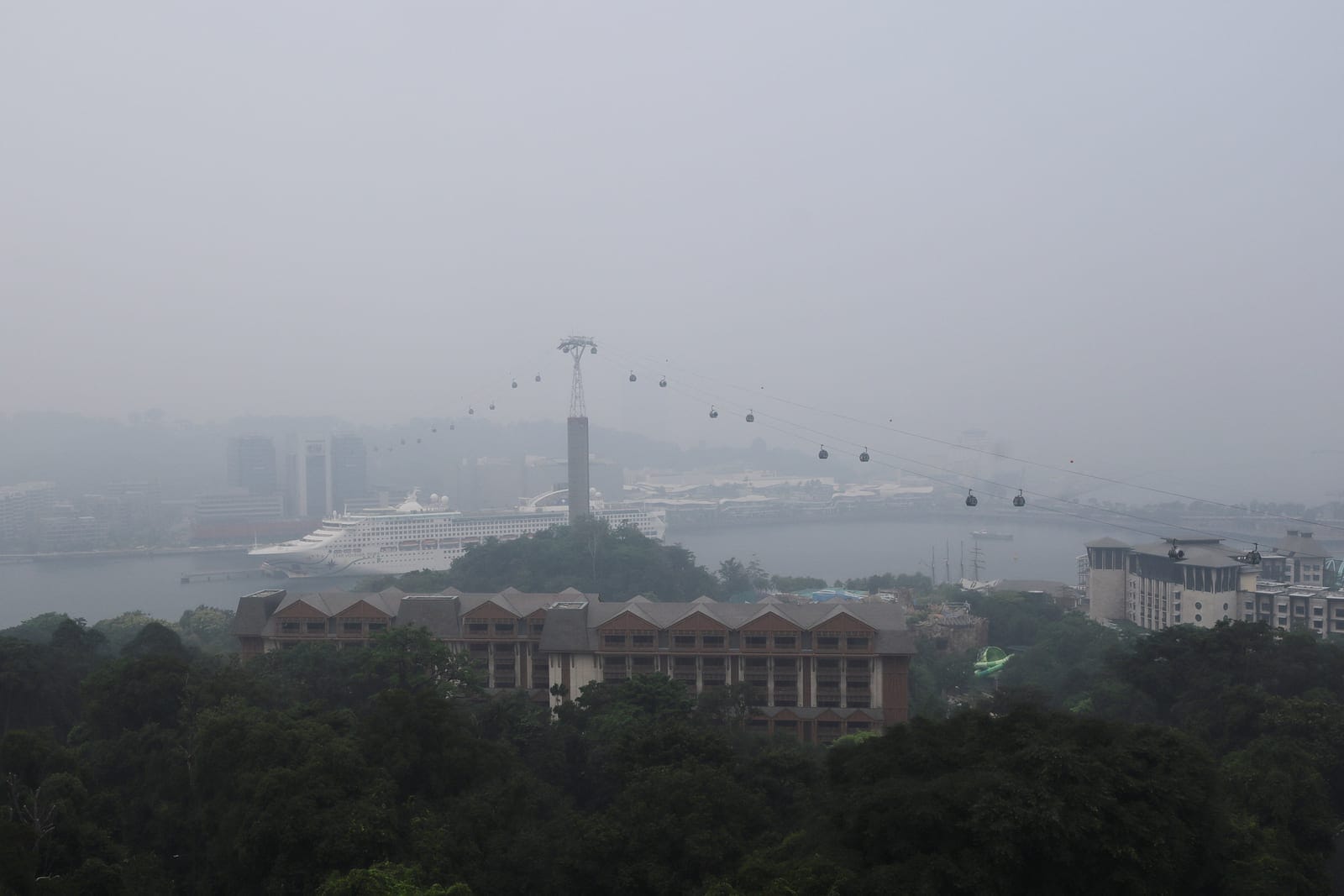 Singapore cable cars travelling towards Mount Faber station are shrouded in haze as smoke from regional forest fires reduces visibility across the city-state, in Singapore, October 14, 2026. REUTERS/Suhaimi Abdullah