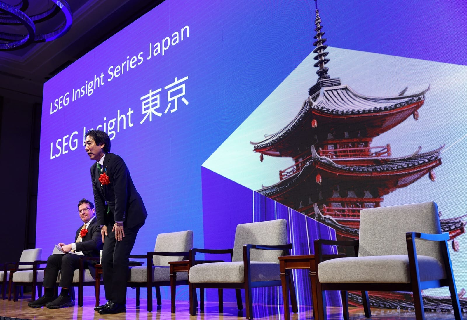 Japan's Minister of State for Economic and Fiscal Policy Minoru Kiuchi, flanked by Rocky Swift, Reuters Chief Correspondent, Japan Markets, attend the Reuters NEXT Newsmaker event in Tokyo, Japan, October 15, 2026. REUTERS/Issei Kato
