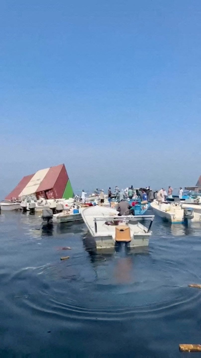 Containers float in the water after a vessel sank near the Strait of Hormuz off the coast of Oman, in this still image obtained from a social media video, released October 14, 2026. Social Media/via REUTERS REUTERS/Social Media