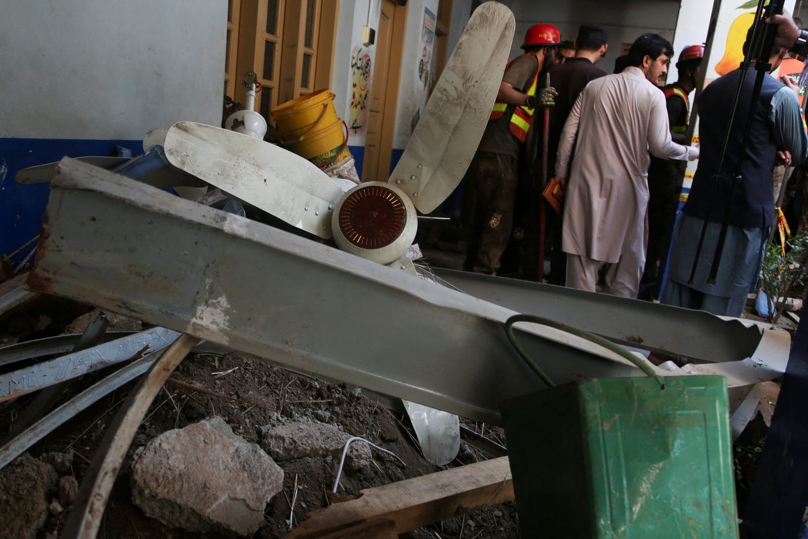 People stand near rubble after a school roof collapse in Peshawar, Pakistan, October 15, 2026. REUTERS REUTERS/Reuters