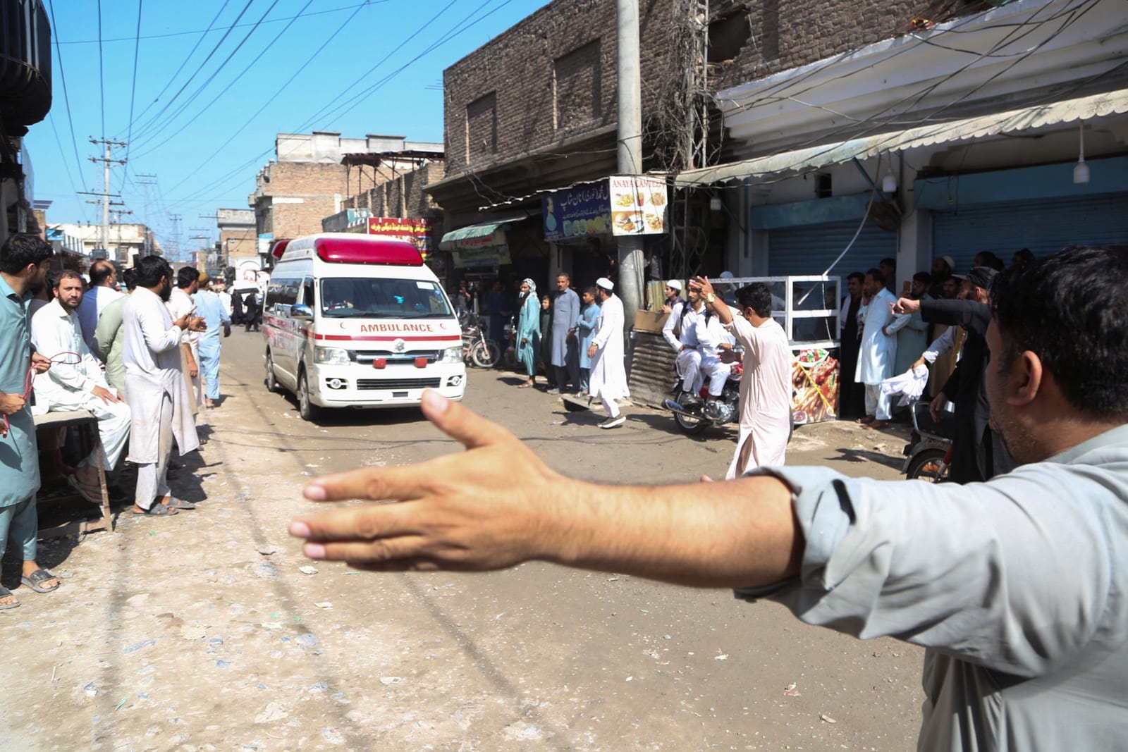 A man guides an ambulance along a street after a school roof collapse in Peshawar, Pakistan, October 15, 2026. REUTERS REUTERS/Reuters