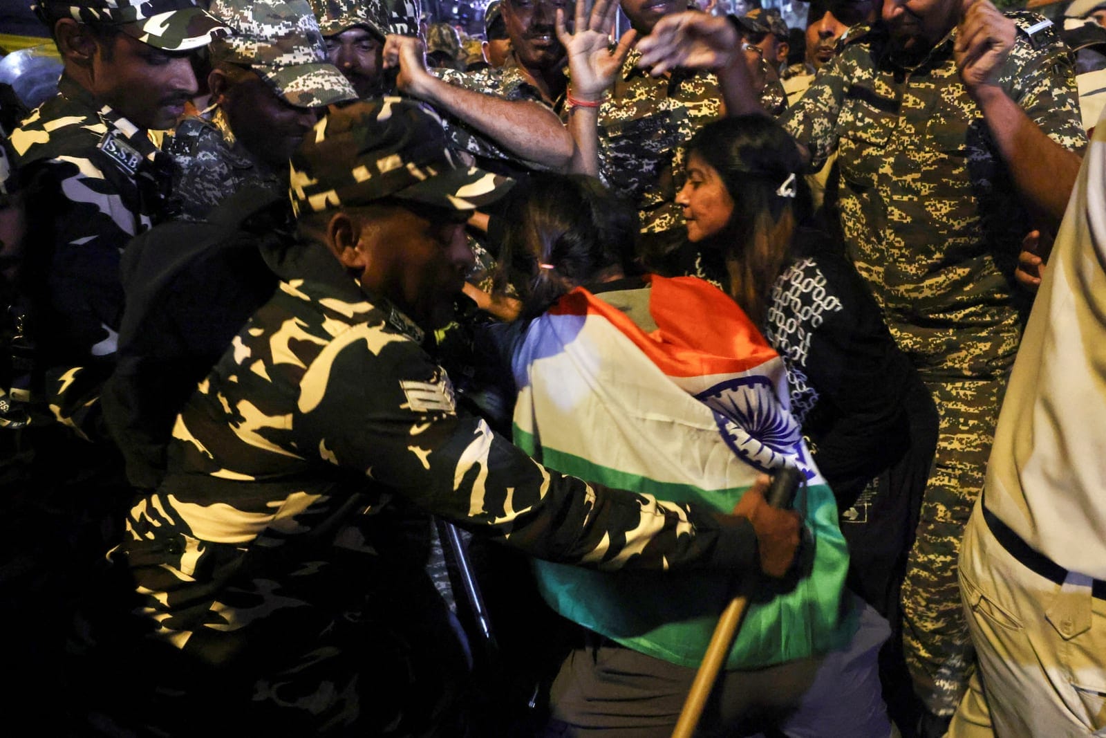 Security personnel detain a protester during a flag rally organised by the Cockroach Janta Party (CJP), demanding the resignation of India's Chief Election Commissioner Gyanesh Kumar, in New Delhi, India, October 16, 2026. REUTERS/Priyanshu Singh