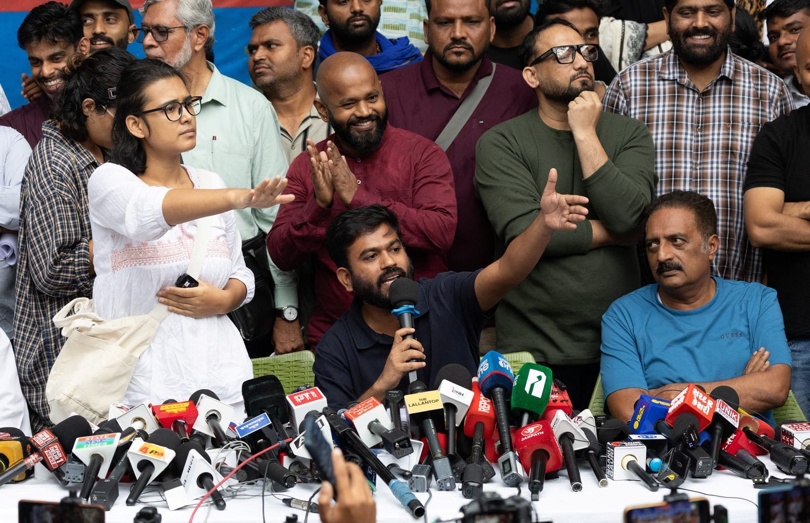 Abhijeet Dipke, founder of the Cockroach Janata Party (CJP) and Neha Bora, national president of the All India Students' Association (AISA) gesture as they addresses a press conference in New Delhi, India, October 15, 2026. REUTERS/Adnan Abidi