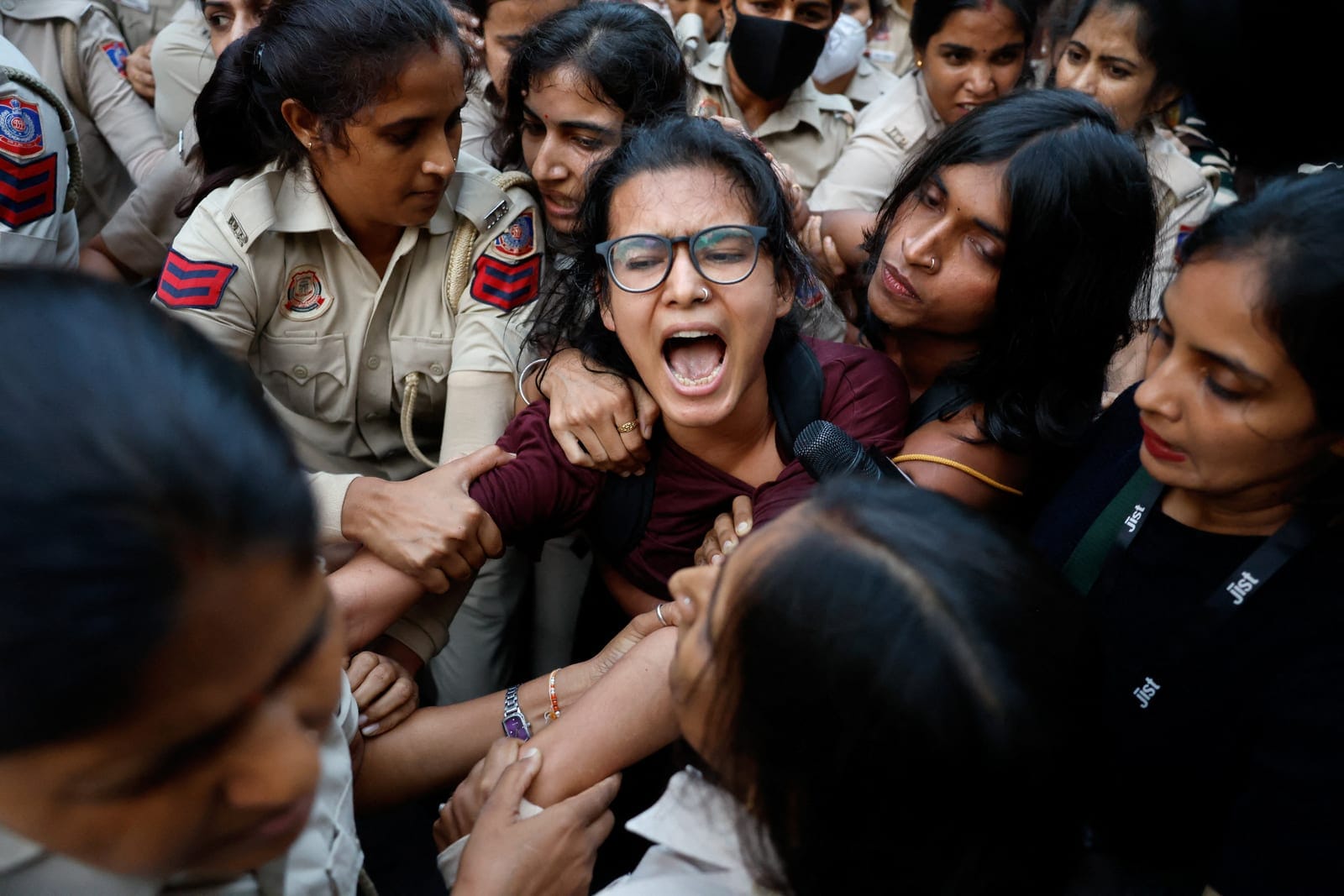 Police officers detain All India Students' Association (AISA) President Neha Bora during a flag rally seeking the resignation of India's Chief Election Commissioner Gyanesh Kumar, in New Delhi, India, October 16, 2026. REUTERS/Adnan Abidi