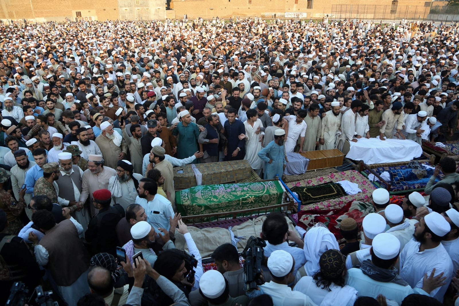 People gather around the coffins of victims who died n a school roof collapse, during a funeral in Peshawar, Pakistan, October 15, 2026. REUTERS TPX IMAGES OF THE DAY REUTERS/Reuters