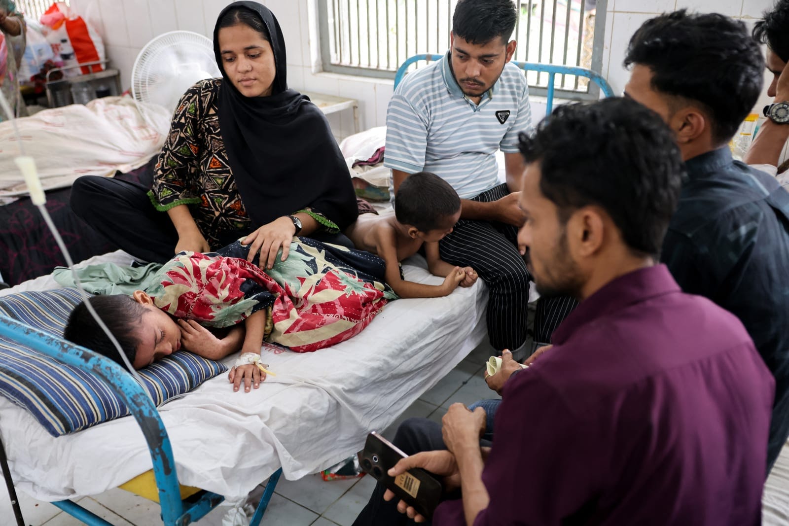 Relatives gather around Masum, 8, who is receiving treatment at the overcrowded measles isolation ward of Shahid Shamsuddin Ahmed Hospital after developing symptoms of measles, in Sylhet, Bangladesh, September 12, 2026. REUTERS/Mohammad Ponir Hossain