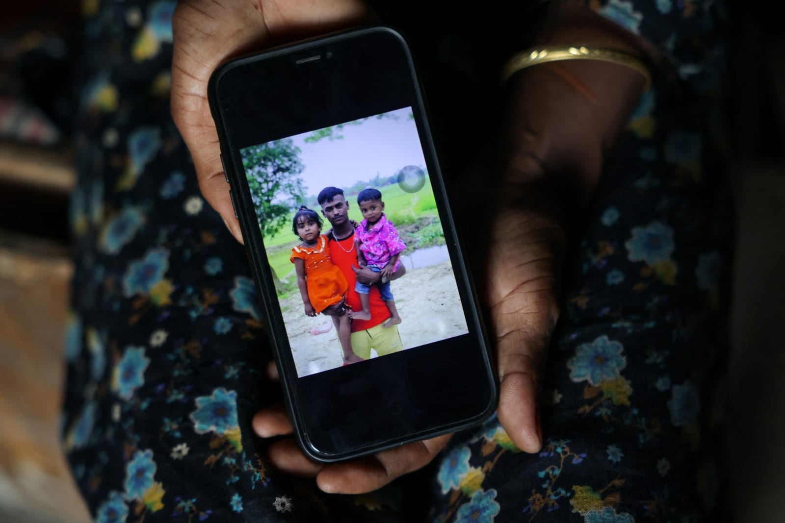 Sajina Begum, 27, shows a family picture on her smartphone featuring her 34-month-old son, Arman Hossain, who died of suspected measles during a recent deadly outbreak, in Sunamganj, Bangladesh, September 15, 2026. REUTERS/Mohammad Ponir Hossain