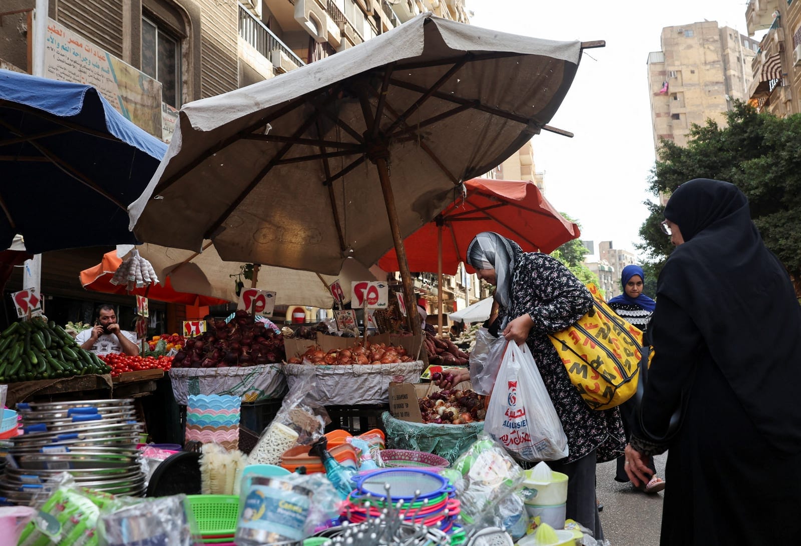 Egyptians shop at a fruit and vegetable market, as further increases in food prices could heighten the risk of social unrest and prompt governments of major producing countries to impose export restrictions, potentially worsening supply shortages, in