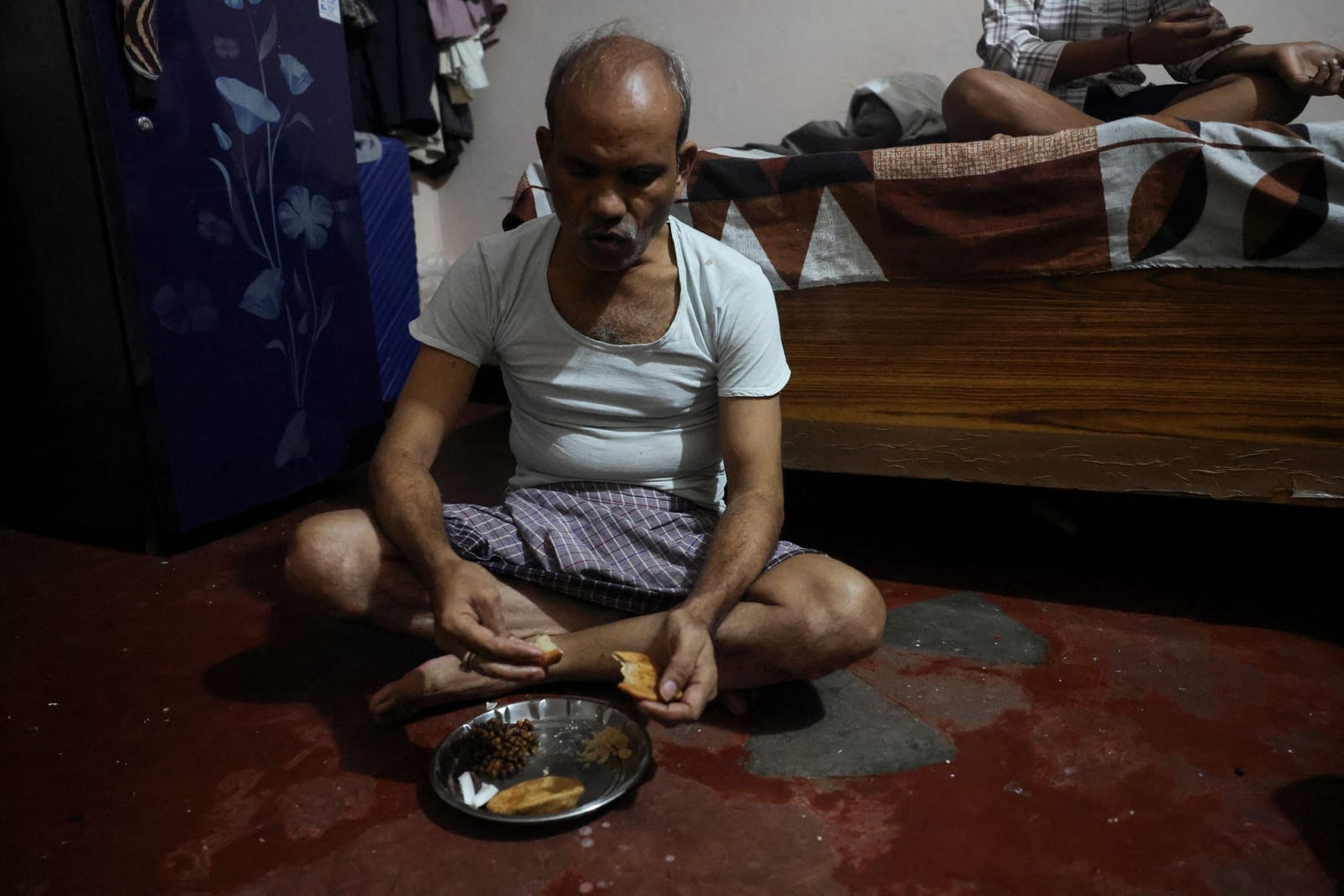 Kamta Prasad, 53, a voter who is listed as "Kanta Prasad" and is declared dead in the Special Intensive Revision (SIR) list published on August 1, 2026, eats food at his house in New Delhi, India, October 19, 2026. REUTERS/Priyanshu Singh