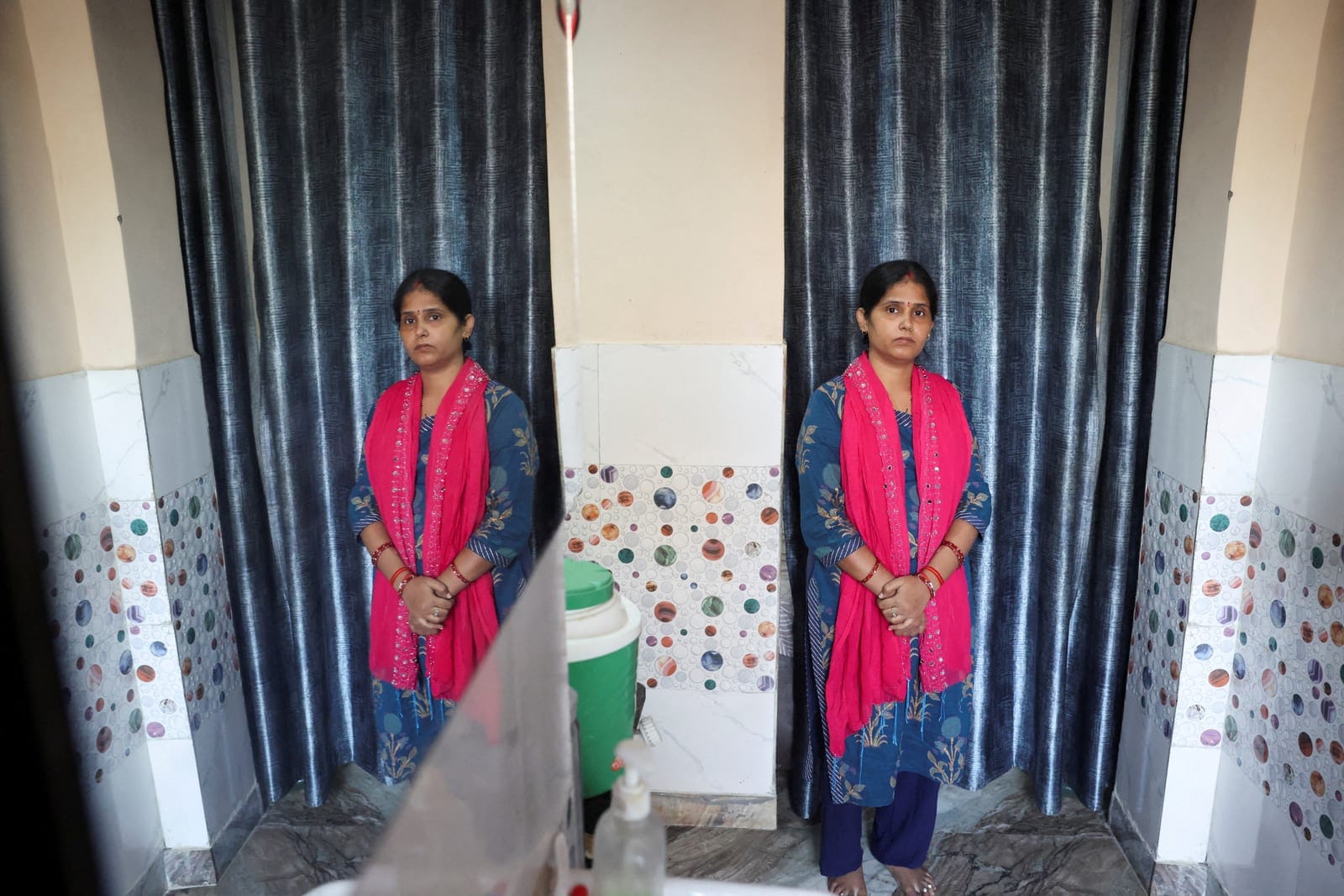 Mamta, a voter whose name was removed from the voter list and put under the Permanently Shifted category in the Special Intensive Revision (SIR) list published on August 1, 2026, poses for a photograph during a Reuters interview at her house in New D