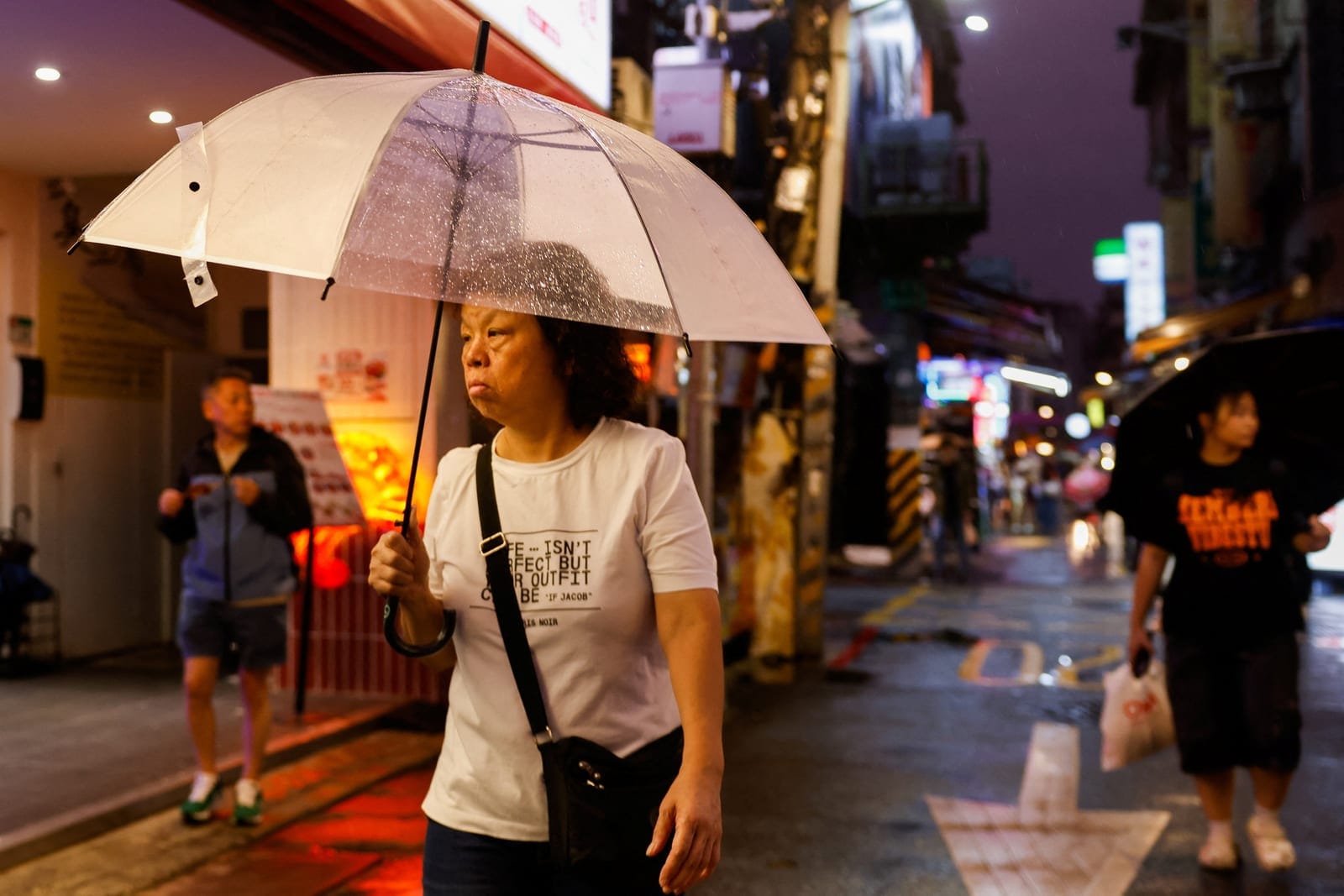 People walk through a market during rainfall as Typhoon Champi approaches, in Taipei, Taiwan, October 22, 2026. REUTERS/Ann Wang