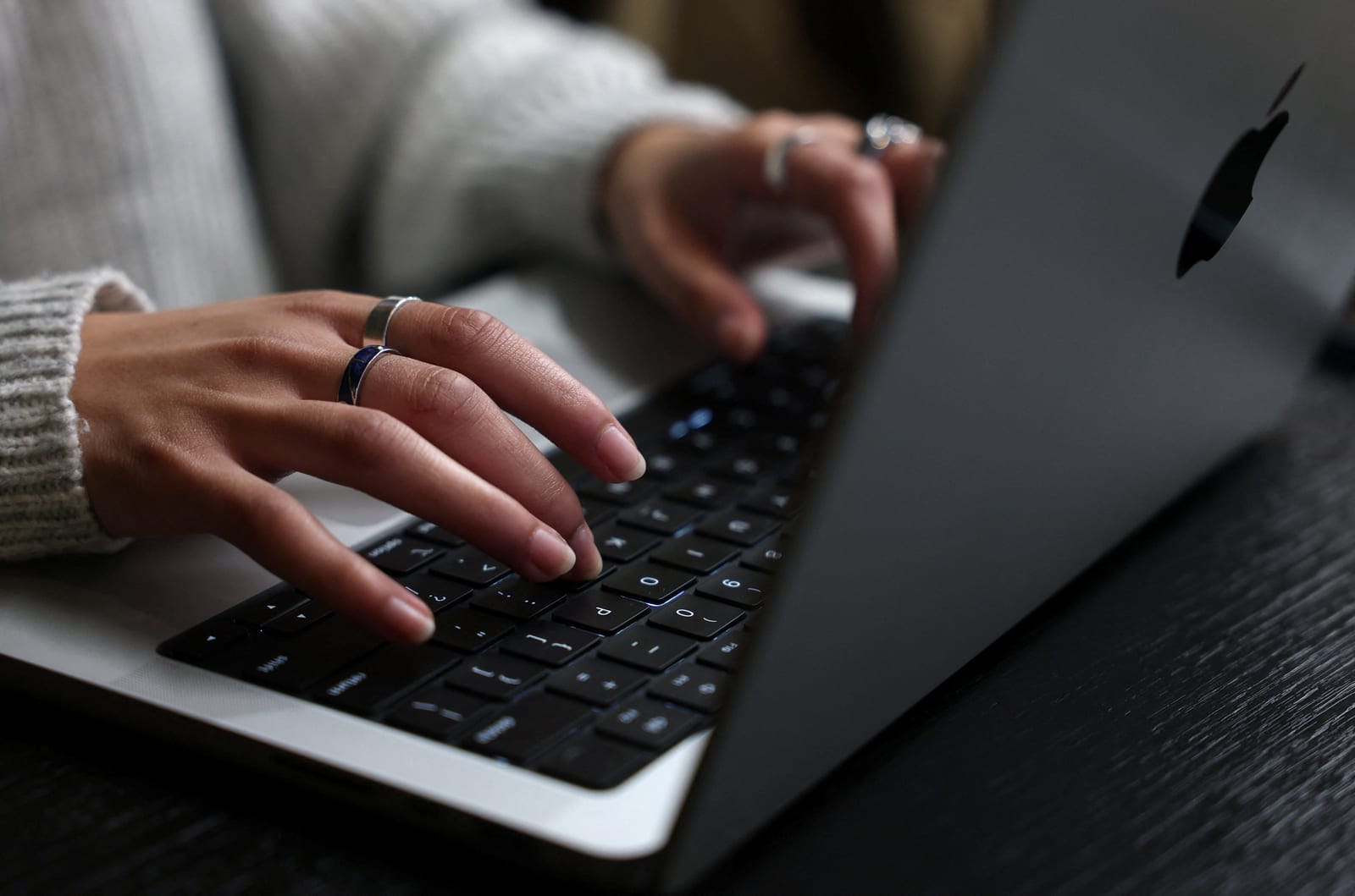 A person works on their laptop at a cafe in London, Britain, October 21, 2026. Government websites across Europe went dark on Wednesday as operators raced to patch two critical vulnerabilities in PHP, one of the most widely used programming languages