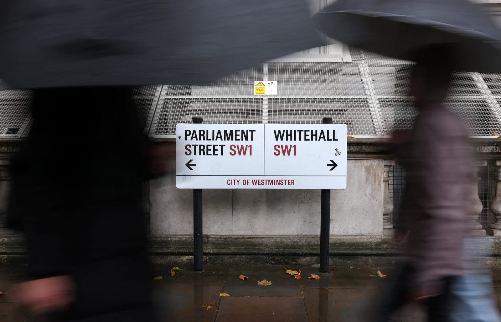 People walk past street signs in Whitehall, the centre of British government buildings in London, Britain, October 21, 2026. Government websites across Europe went dark on Wednesday as operators raced to patch two critical vulnerabilities in PHP, one