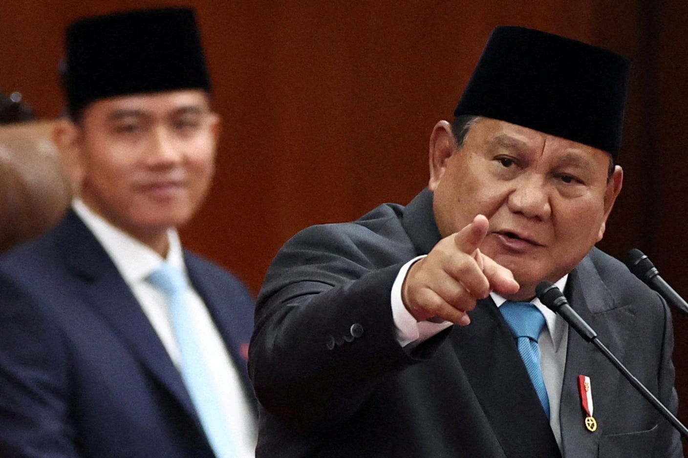 FILE PHOTO: Indonesian President Prabowo Subianto gestures while delivering his speech on economic policies and 2027 fiscal plan to parliament members, as Vice President Gibran Rakabuming Raka reacts, at the parliament building in Jakarta, Indonesia,