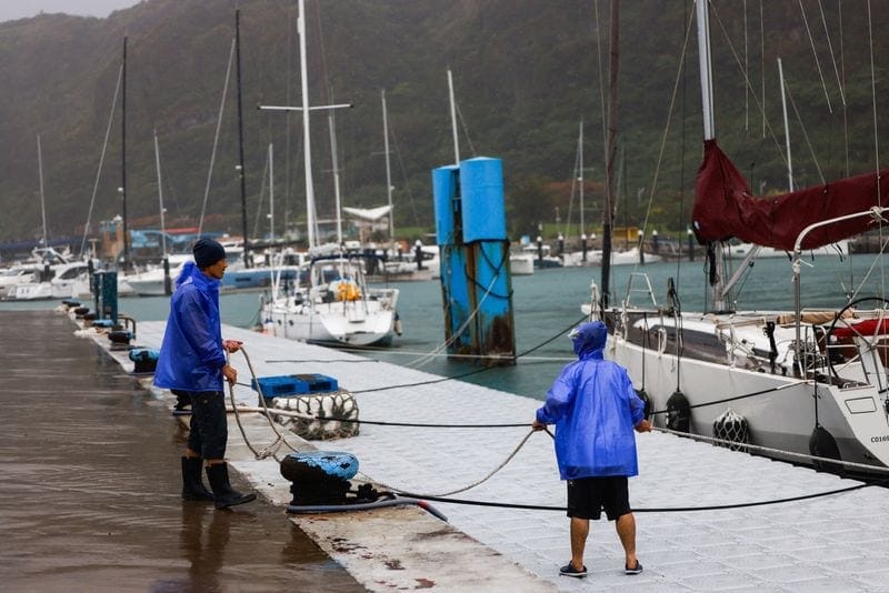 People secure a boat as Typhoon Champi approaches Taiwan, at Badouzi Fishing Port in Keelung, Taiwan, October 23, 2026. REUTERS/Ann Wang