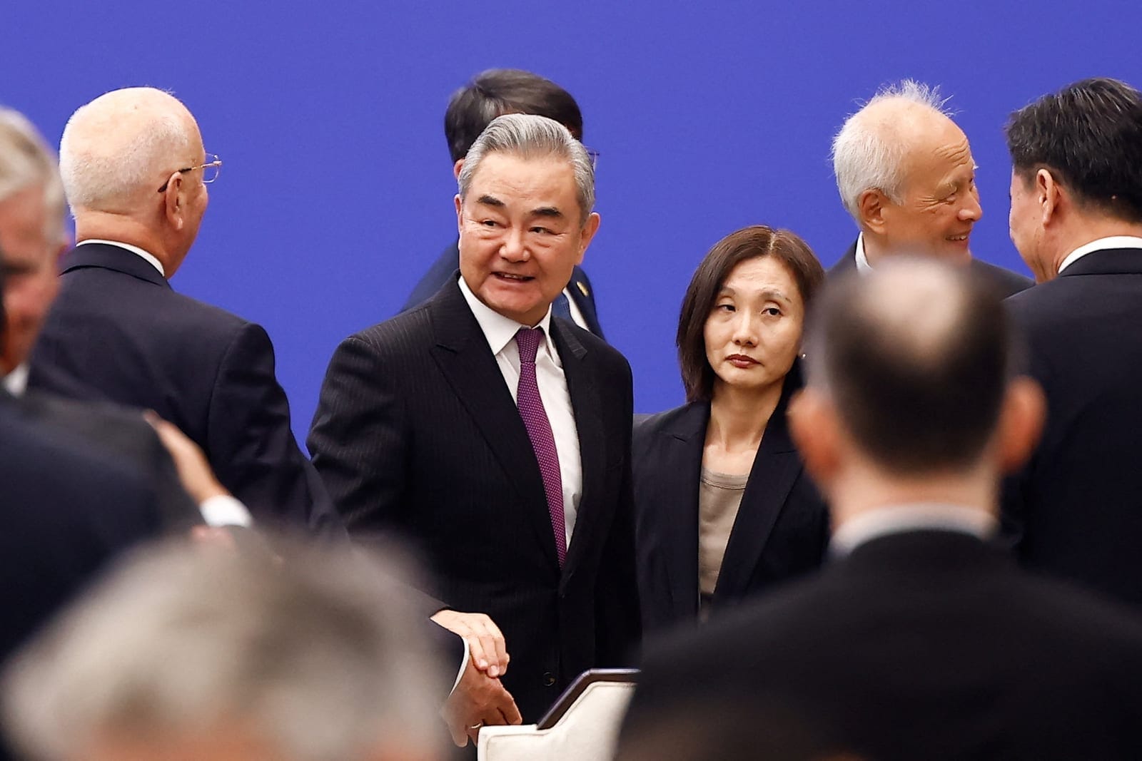 Chinese Foreign Minister Wang Yi reacts as he leaves the hall after the opening ceremony for the inaugural Global Governance Forum in Xiongan New Area, Hebei province, China, October 23, 2026. REUTERS/Maxim Shemetov
