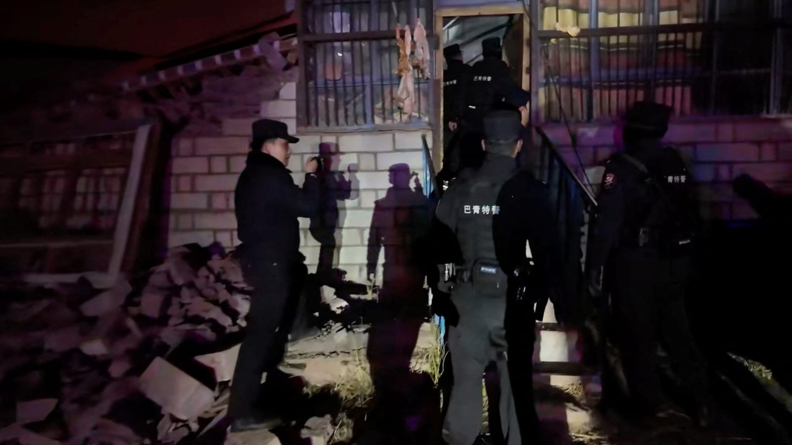 Emergency services personnel at a damaged building following an earthquake, at a location given as Nagqu, Tibet Autonomous Region, China in this still image from video released October 23, 2026. Nagqu Police Department/Handout via REUTERS REUTERS/Nag