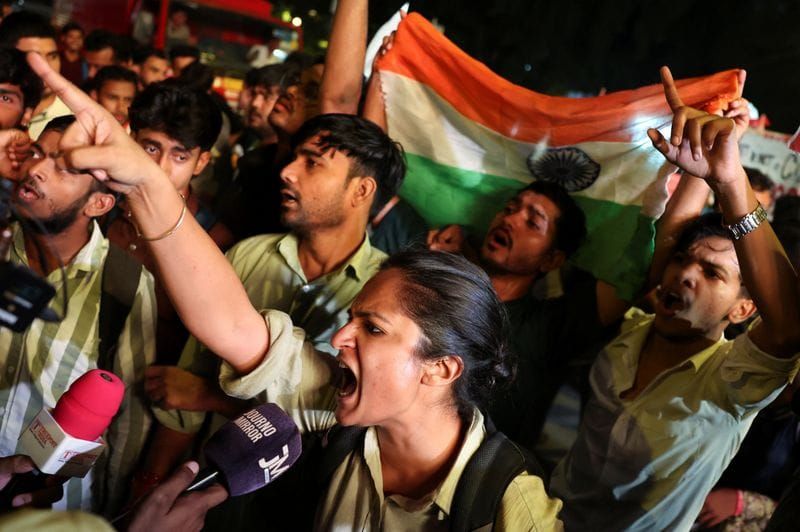 Protesters chant slogans as they take part in a flag rally by the Cockroach Janta Party (CJP) seeking the resignation of India's Chief Election Commissioner Gyanesh Kumar, in New Delhi