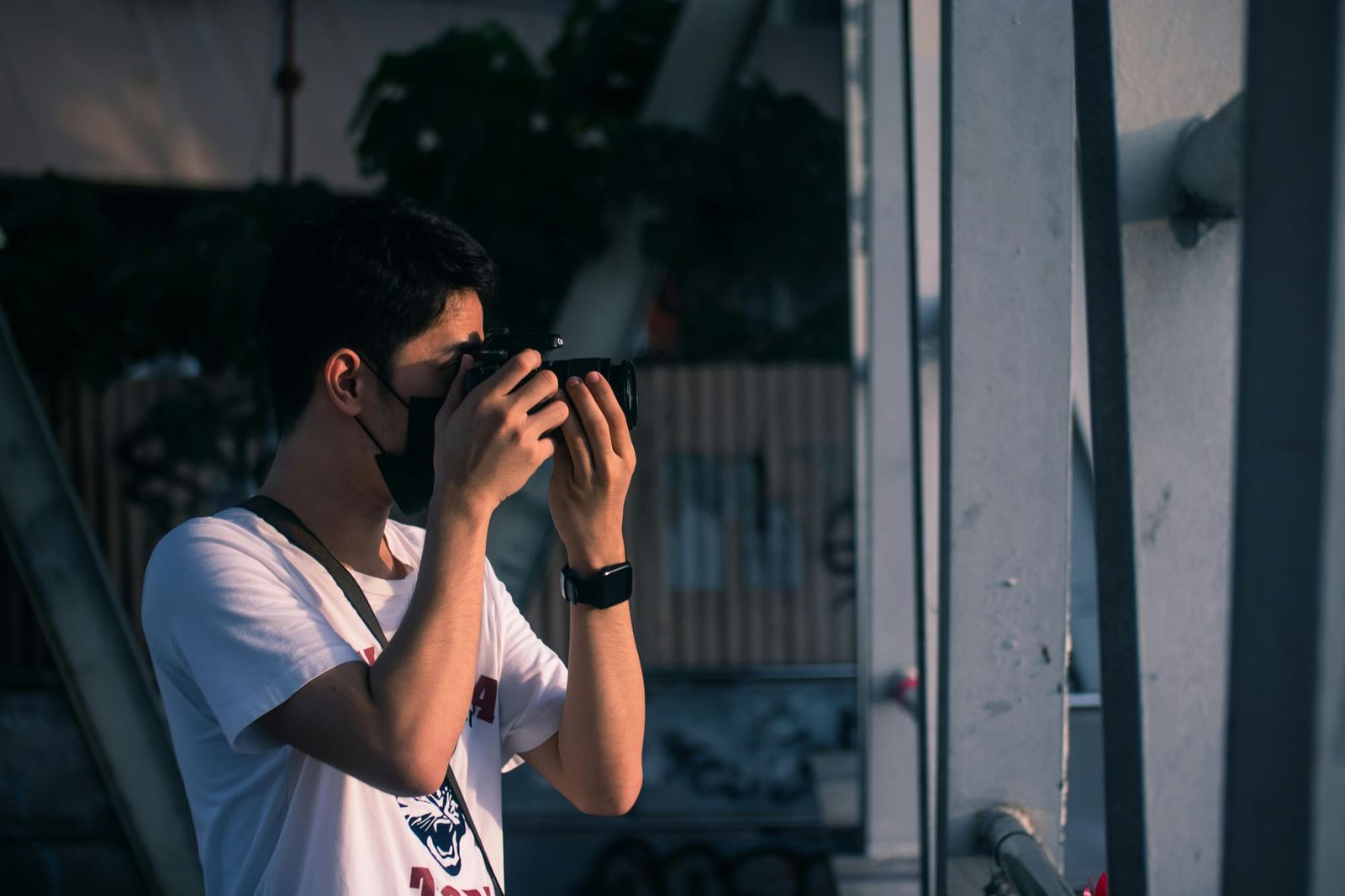 Side view of a man taking pictures