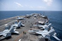 U.S. Navy sailors work on the flight deck of the aircraft carrier USS George Washington as it transits the Arabian Sea