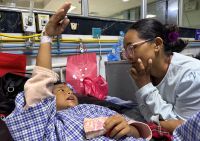 Matti Maya Tamang meets with her son Zoyal Ghale two days after devastating floods in Nepal