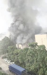 Smoke rises from a structure after a fire broke out at a textile factory in Foshan