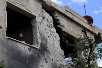 Mariam al-Yaghi ,67, Lebanese resident from West Zawtar stands in her damaged house in southern Lebanon,