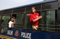 Neha Bora, National President of the All India Students' Association (AISA), shouts from a police vehicle after being detained during a protest organised by the Cockroach Janta Party (CJP)