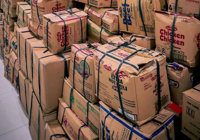 Large stack of cardboard boxes in a warehouse setting in Central Visayas, Philippines.
