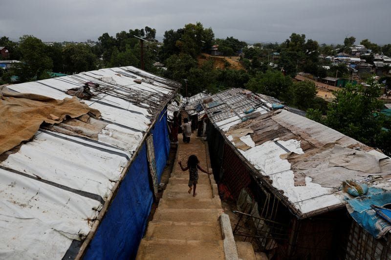 A Rohingya refugee child runs down the stairs of a refugee camp in Cox's Bazar