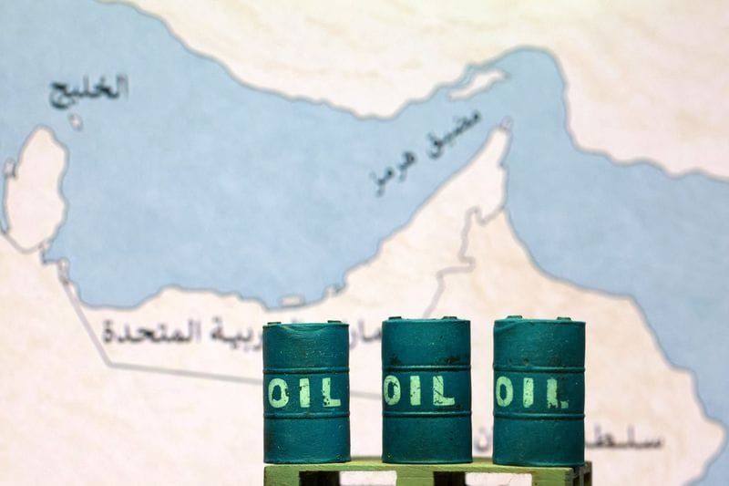 Illustration shows map showing the Strait of Hormuz, also known as Madiq Hurmuz, and 3D printed oil barrels