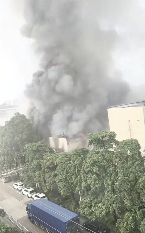 Smoke rises from a structure after a fire broke out at a textile factory in Foshan