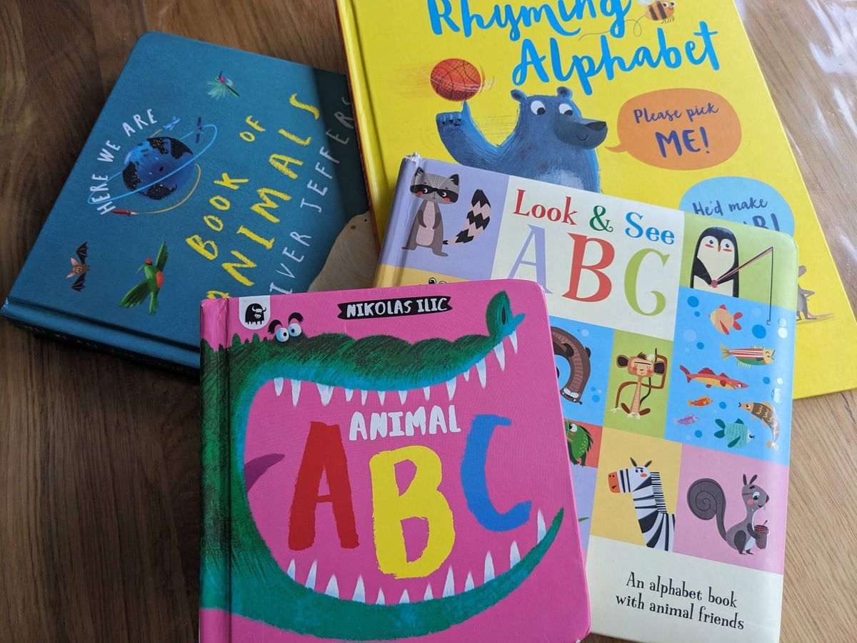 A colourful pile of animal A-Z books for pre-schoolers. Clockwise from top The Usborne Rhyming Alphabet, Look & See ABC, Animal ABC and Book of Animals