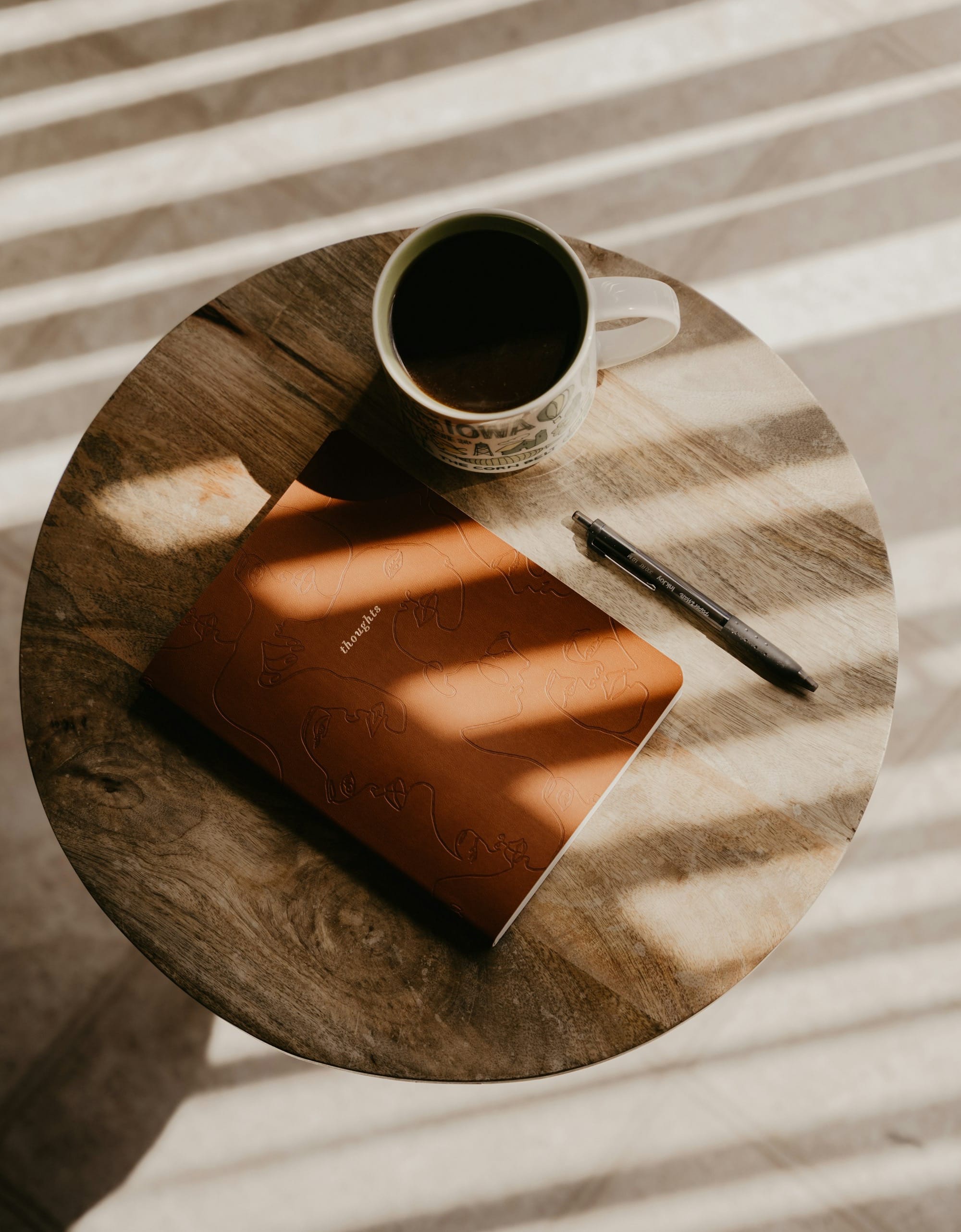 a cup of coffee and a notebook on a table