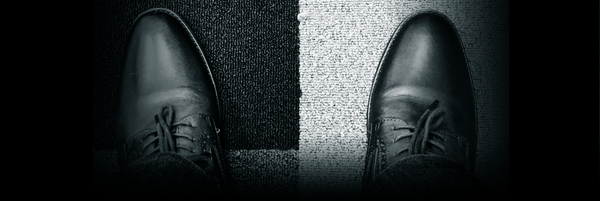 Mustavalkoinen kuva kengistä.