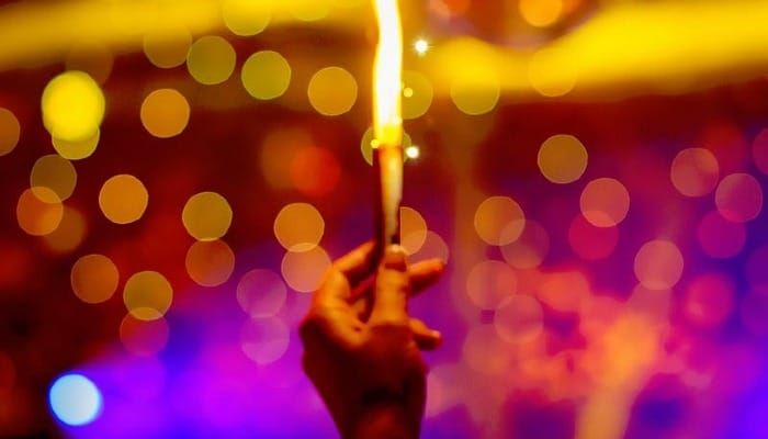 red colors with a bright flame held by a human hand