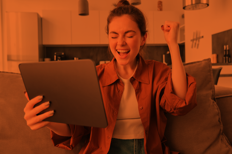 Young job seeker looking happy holding a tablet. 