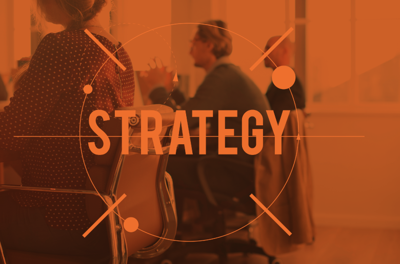 Professionals in a meeting with a layover text "STRATEGY"