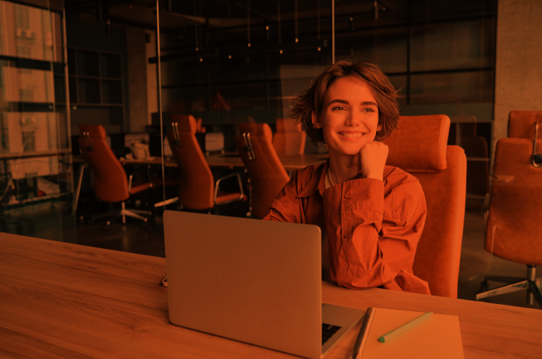 Young professional working on a laptop in a modern office, representing career development and jobs in Cyprus