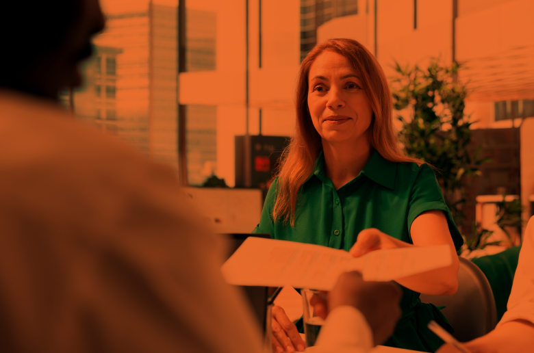 Woman handing over a piece of paper to an HR manager.
