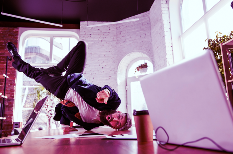 Employee dancing on desk. 