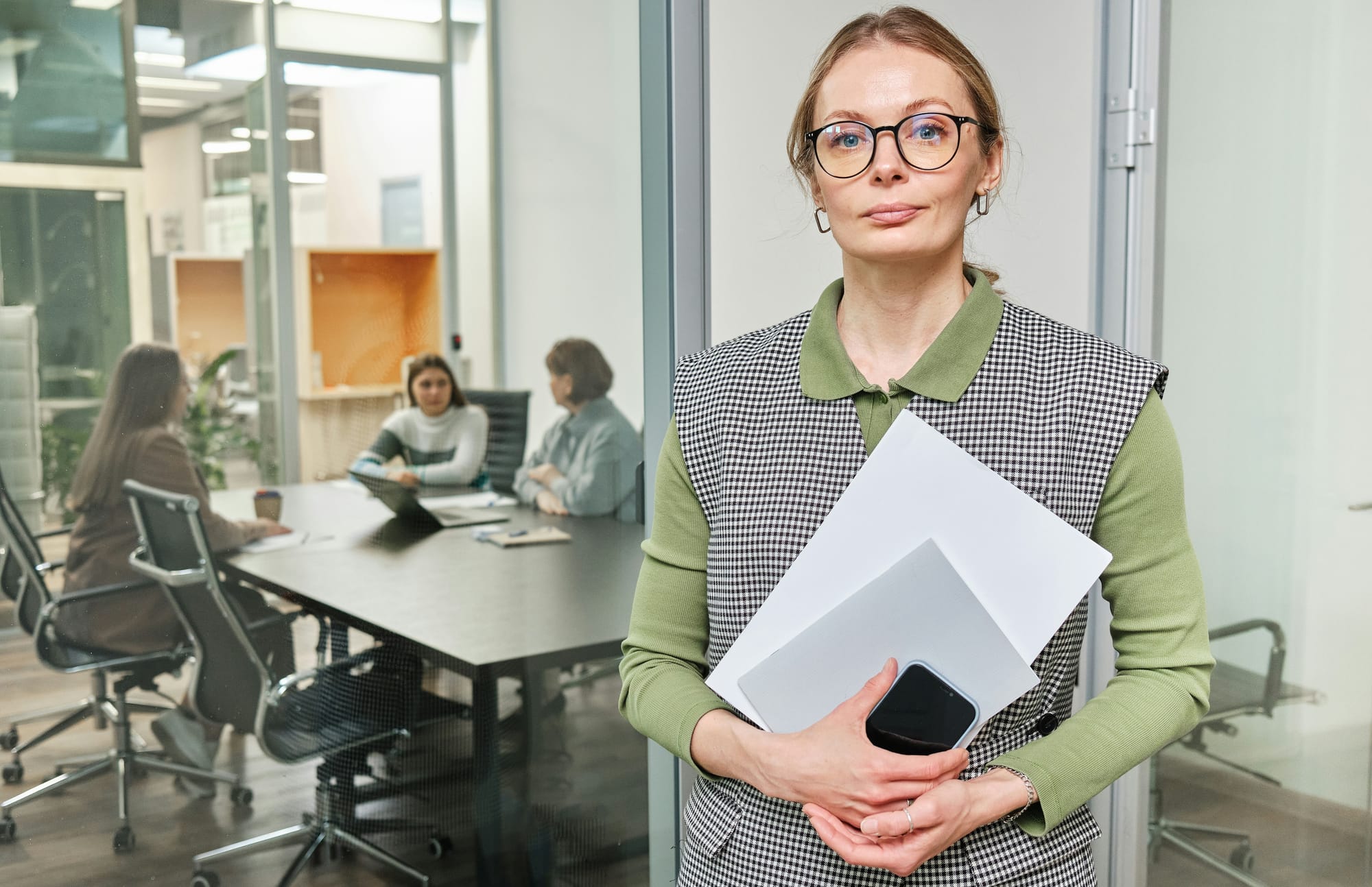 HR employee standing in an office, symbolizing the role of human resources in the modern workplace.