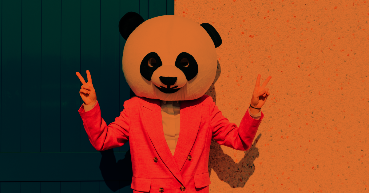 Person wearing a panda mask on their head.